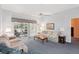 Comfortable living area featuring plush carpet, ample seating, and sliding doors to an outdoor patio at 2243 Worthington Greens Dr, Sun City Center, FL 33573