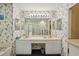 Main bathroom with dual sinks, bathtub, and floral wallpaper at 2243 Worthington Greens Dr, Sun City Center, FL 33573