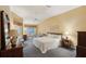 Bright main bedroom with a ceiling fan, ensuite bathroom, and access to the lanai at 2243 Worthington Greens Dr, Sun City Center, FL 33573
