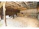 Interior of a horse barn featuring an open design, wooden beams, and functional fencing at 25590 Olympia Rd, Brooksville, FL 34601