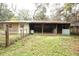Rustic barn structure with open storage space, ideal for agricultural use or potential conversion, with greenery surrounding it at 25590 Olympia Rd, Brooksville, FL 34601