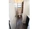 Narrow bathroom with a toilet, tub/shower combo, and dark wood-look flooring at 25590 Olympia Rd, Brooksville, FL 34601