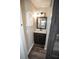 Charming bathroom featuring a wood-look vanity, unique mirror, and modern lighting at 25590 Olympia Rd, Brooksville, FL 34601