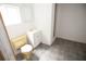 Small and simple bathroom with a toilet, sink, and mirror, offering essential facilities in a compact space at 25590 Olympia Rd, Brooksville, FL 34601