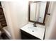 Bathroom featuring a dark vanity, white countertop and wood-look flooring at 25590 Olympia Rd, Brooksville, FL 34601