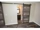 Bathroom with rustic vanity, decorative lighting, and barn-style sliding door at 25590 Olympia Rd, Brooksville, FL 34601