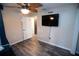 Bright bedroom with a ceiling fan and a mounted television on the wall at 25590 Olympia Rd, Brooksville, FL 34601