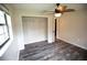 Bedroom with closet, ceiling fan, door to ensuite, and natural light at 25590 Olympia Rd, Brooksville, FL 34601