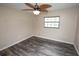 A bright bedroom with natural light, a ceiling fan, and neutral decor at 25590 Olympia Rd, Brooksville, FL 34601