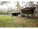 Home exterior featuring a barn and covered structure on a spacious green lot at 25590 Olympia Rd, Brooksville, FL 34601