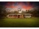 Charming single-story home featuring brick accents, a well-maintained lawn, and an inviting covered entryway at 25590 Olympia Rd, Brooksville, FL 34601