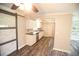 Modern kitchen with white cabinets, stainless steel appliances, granite countertops, and updated flooring at 25590 Olympia Rd, Brooksville, FL 34601