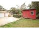 Exterior view of a red storage shed on the property, providing ample space for tools and equipment at 25590 Olympia Rd, Brooksville, FL 34601