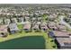 Scenic aerial view of a residential community featuring lush landscaping and lakeside properties for a serene setting at 30280 Southernwood Ct, Wesley Chapel, FL 33543
