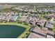 High aerial view of a neighborhood dotted with ponds and lakes, showcasing the community's layout and green spaces at 30280 Southernwood Ct, Wesley Chapel, FL 33543