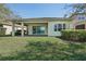 Well-manicured backyard featuring a covered patio and lush green lawn at 30280 Southernwood Ct, Wesley Chapel, FL 33543