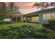 Expansive backyard with a covered patio and well-maintained green lawn at 30280 Southernwood Ct, Wesley Chapel, FL 33543