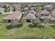Backyard view of lakeside homes with lush lawns extending down to the water's edge at 30280 Southernwood Ct, Wesley Chapel, FL 33543