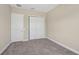 Comfortable bedroom with carpet flooring, neutral walls, and ample closet space at 30280 Southernwood Ct, Wesley Chapel, FL 33543