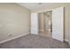 Carpeted bedroom with white trim and double doors to another room at 30280 Southernwood Ct, Wesley Chapel, FL 33543