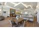 Bright common area featuring a bar, multiple seating areas, and modern decor at 30280 Southernwood Ct, Wesley Chapel, FL 33543