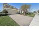 A well-maintained house featuring a brick driveway and attached two-car garage at 30280 Southernwood Ct, Wesley Chapel, FL 33543