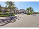 Clubhouse exterior boasts lush landscaping, palm trees, and a circular drive at 30280 Southernwood Ct, Wesley Chapel, FL 33543