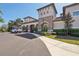 Beautiful multi-story building with stone accents and lush landscaping under a clear blue sky at 30280 Southernwood Ct, Wesley Chapel, FL 33543