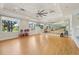 Bright fitness studio with mirrored wall, hardwood floors, and exercise equipment at 30280 Southernwood Ct, Wesley Chapel, FL 33543