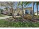 Charming home featuring a brick driveway, two-car garage, and mature landscaping in a well-maintained yard at 30280 Southernwood Ct, Wesley Chapel, FL 33543