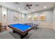 Cozy game room with a pool table, ping pong table, and tasteful wall art at 30280 Southernwood Ct, Wesley Chapel, FL 33543