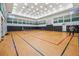 Spacious gym with hardwood floors, basketball court, and pickleball net at 30280 Southernwood Ct, Wesley Chapel, FL 33543