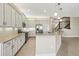 Bright kitchen with white cabinets, granite countertops, and stainless steel appliances at 30280 Southernwood Ct, Wesley Chapel, FL 33543