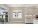 Bright breakfast nook with sliding glass doors, a chandelier, and white cabinets at 30280 Southernwood Ct, Wesley Chapel, FL 33543