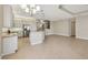 Open-concept kitchen with stainless steel appliances, an island with seating, and modern pendant lighting at 30280 Southernwood Ct, Wesley Chapel, FL 33543