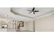 Open-concept living area with neutral walls, a ceiling fan, and seamless transition to the kitchen at 30280 Southernwood Ct, Wesley Chapel, FL 33543