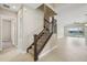 Elegant staircase featuring carpeted steps and decorative wrought iron railing at 30280 Southernwood Ct, Wesley Chapel, FL 33543