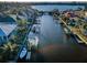 Aerial view of a waterway lined with homes, private docks and boats, showcasing waterfront living at 315 Manatee Ln, Tarpon Springs, FL 34689