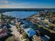 Scenic aerial view of a waterfront neighborhood with well-maintained homes and canals leading to a large body of water at 315 Manatee Ln, Tarpon Springs, FL 34689