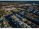 An aerial view showcasing canal-front homes with docks and boats in a residential neighborhood at 315 Manatee Ln, Tarpon Springs, FL 34689