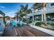 Inviting backyard with a spacious dock, waterfront access, outdoor seating, and lush tropical landscaping for relaxation at 315 Manatee Ln, Tarpon Springs, FL 34689