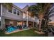 Home's exterior features a lush lawn and spacious patio for outdoor enjoyment at 315 Manatee Ln, Tarpon Springs, FL 34689
