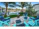 Backyard patio with comfortable seating, a fire pit, and water views, creating an inviting outdoor space at 315 Manatee Ln, Tarpon Springs, FL 34689