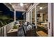 Relaxing outdoor balcony with comfortable seating and view of the living room through sliding glass doors at 315 Manatee Ln, Tarpon Springs, FL 34689
