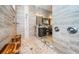 Tiled walk-in shower features a glass door with a mosaic accent strip and tiled walls in this bath at 315 Manatee Ln, Tarpon Springs, FL 34689