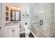 Elegant bathroom features a granite vanity, custom cabinets, and a glass-enclosed shower with mosaic tile accents at 315 Manatee Ln, Tarpon Springs, FL 34689
