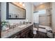 Bathroom featuring a granite countertop, decorative mirror, and a bathtub with a shower at 315 Manatee Ln, Tarpon Springs, FL 34689