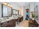 Updated bathroom with double sinks, granite countertops, wooden cabinets, and decorative mirrors at 315 Manatee Ln, Tarpon Springs, FL 34689
