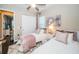 Bedroom featuring twin beds, a closet, a window with blinds, and neutral colors in this bright space at 315 Manatee Ln, Tarpon Springs, FL 34689