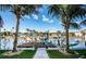 Waterfront property with a dock and lush palms set against a sunny sky at 315 Manatee Ln, Tarpon Springs, FL 34689